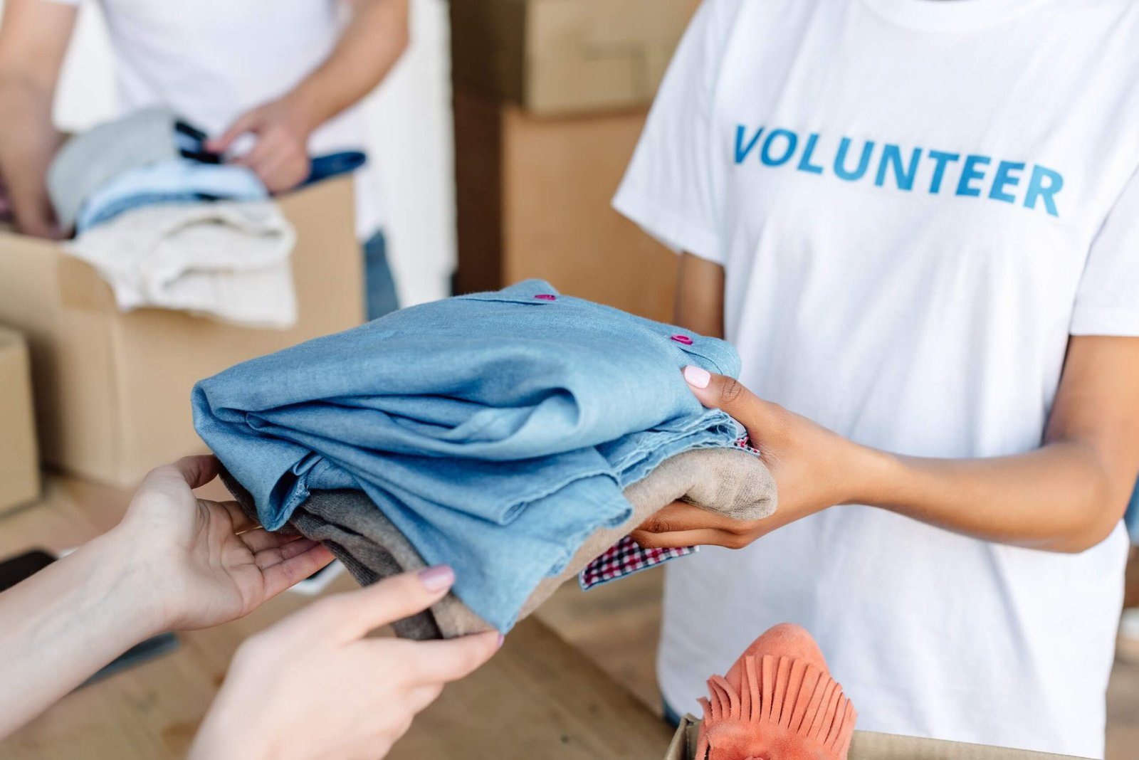 cropped-view-of-volunteer-giving-clothes-to-woman-2022-12-16-21-31-45-utc.jpg